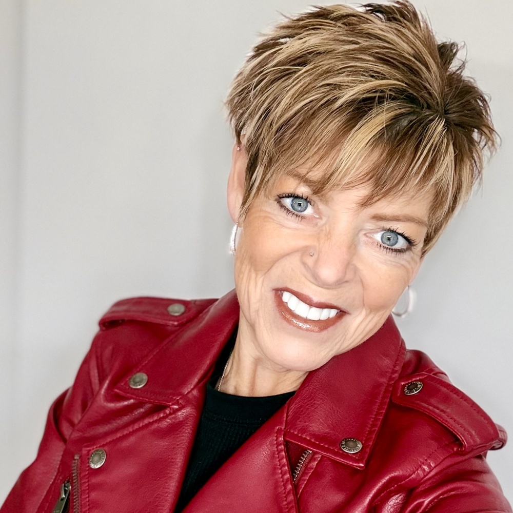 Kelly MacLeod smiling in a red jacket